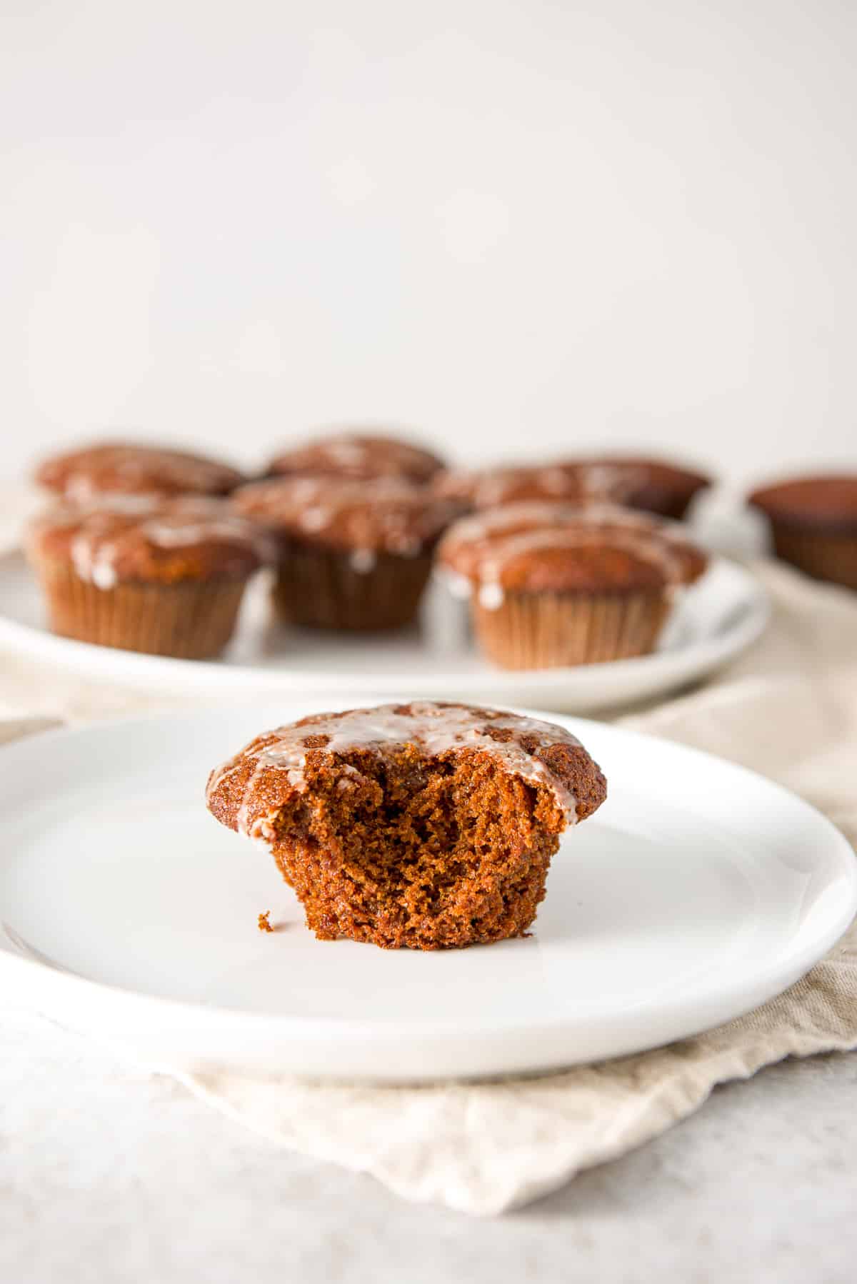 A bite taken out of a glazed gingerbread muffin