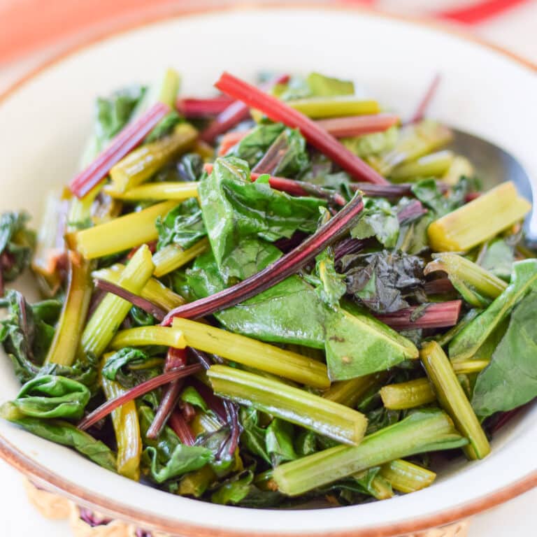 A brown and white bowl filled with the greens