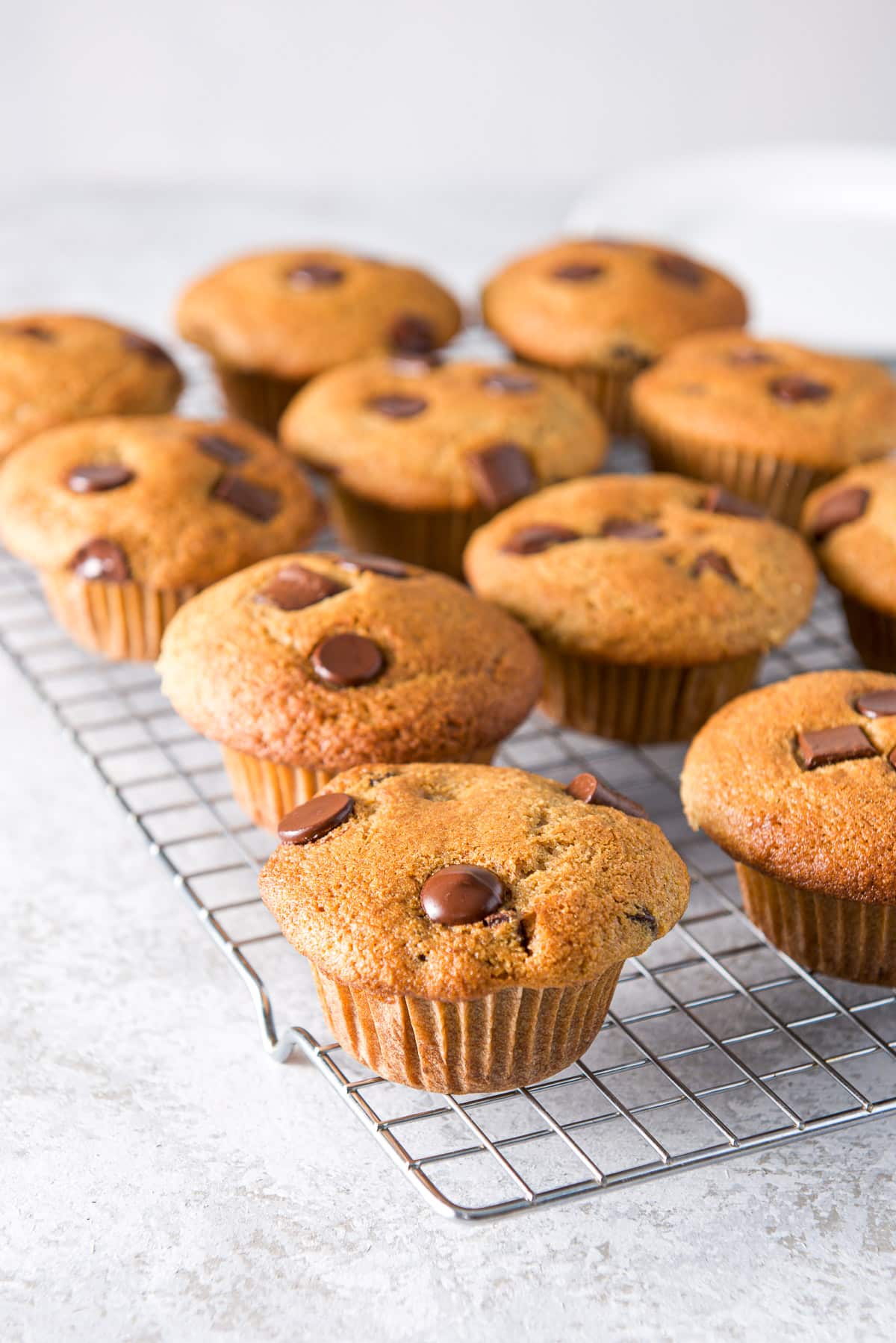 twelve muffins cooling on a wire rack