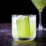 head on view of a double old fashioned glass filled with the gimlet and the martini glass in the back