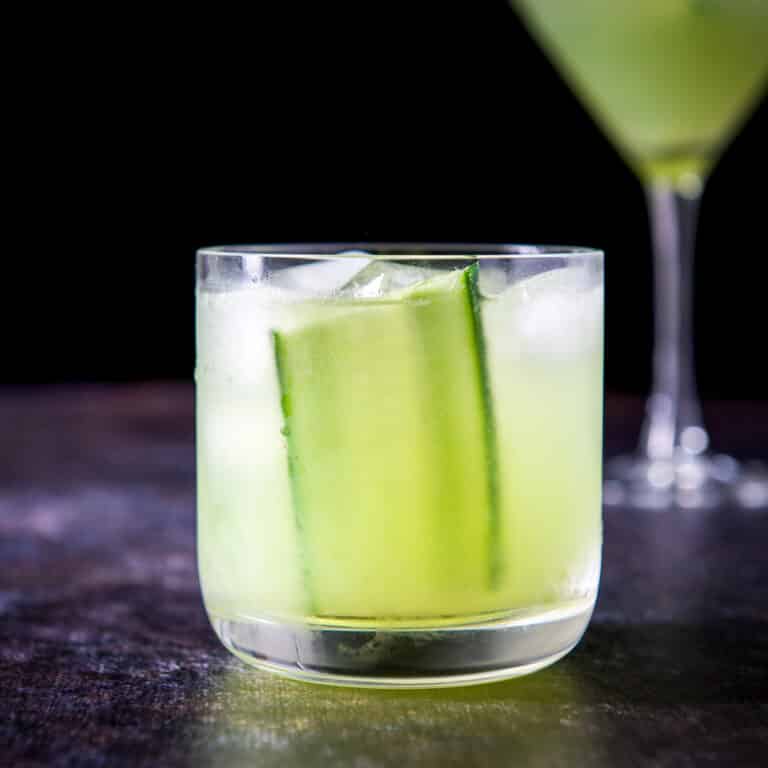 head on view of a double old fashioned glass filled with the gimlet and the martini glass in the back