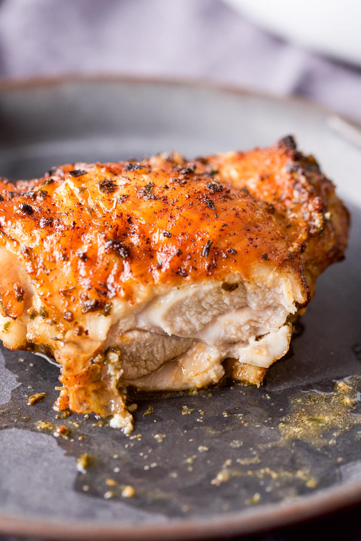 A juicy chicken thigh with a slice taken out of it