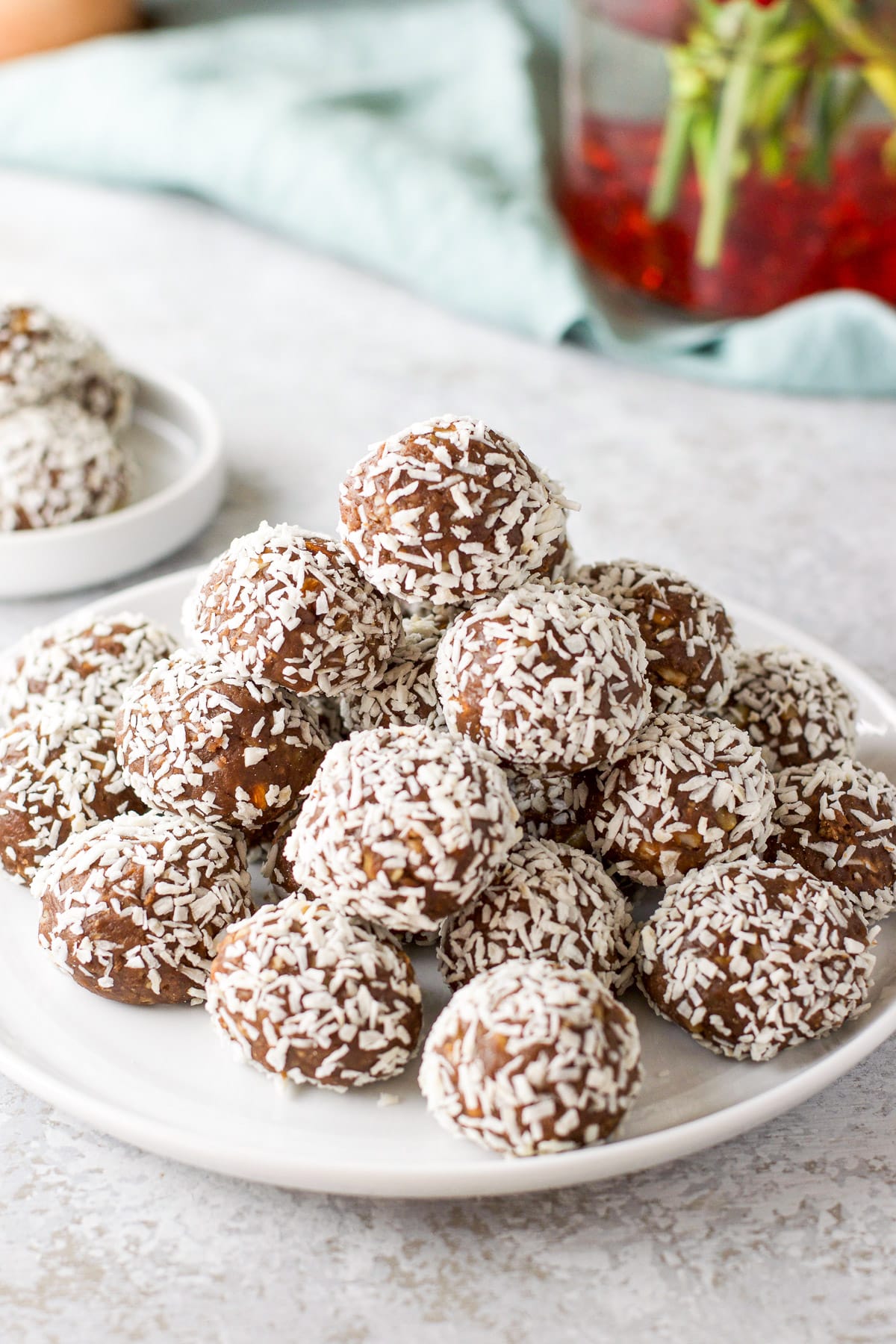 A pile of coconut covered balls on a plate