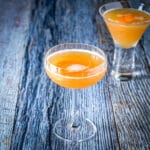 A fluted coup glass filled with the amber cocktail - square
