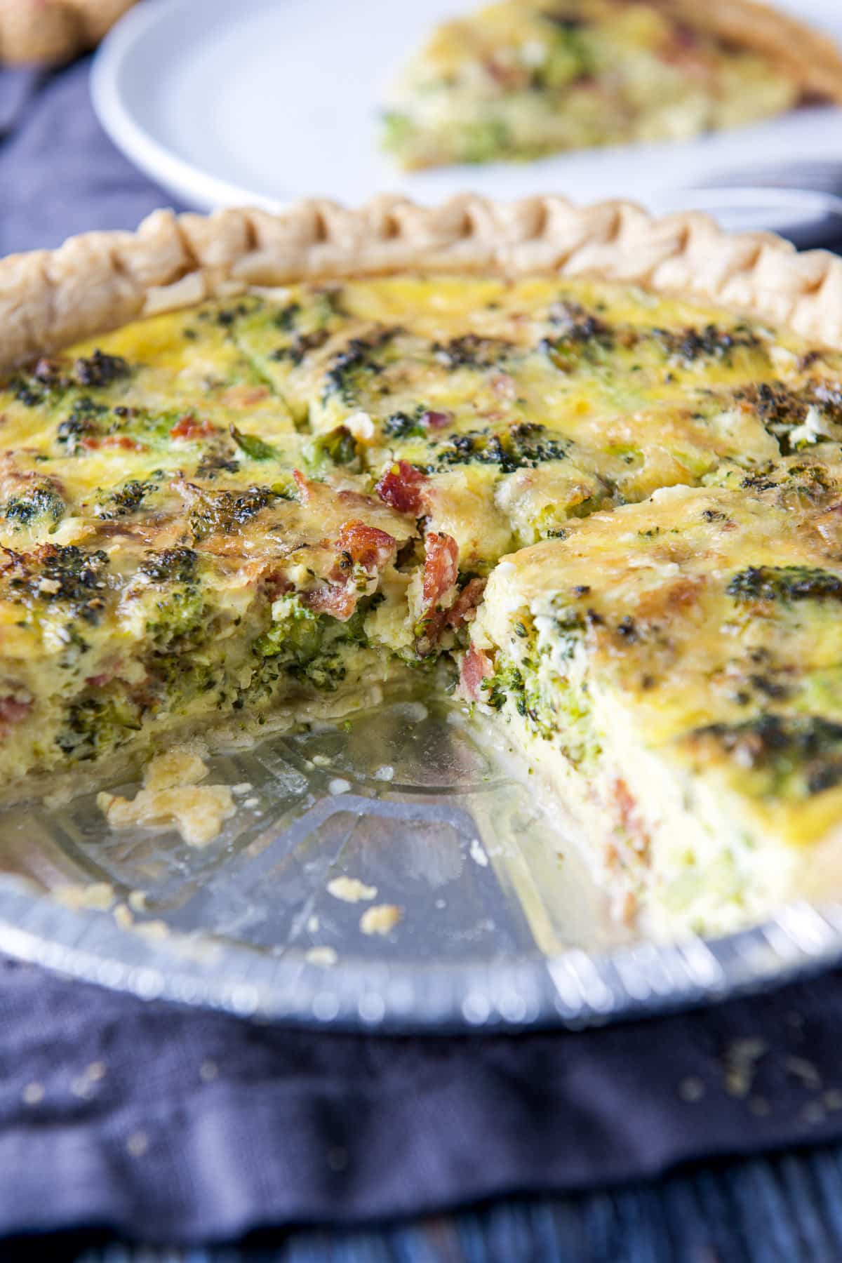 Two slices taken out of the bacon broccoli quiche in the crust
