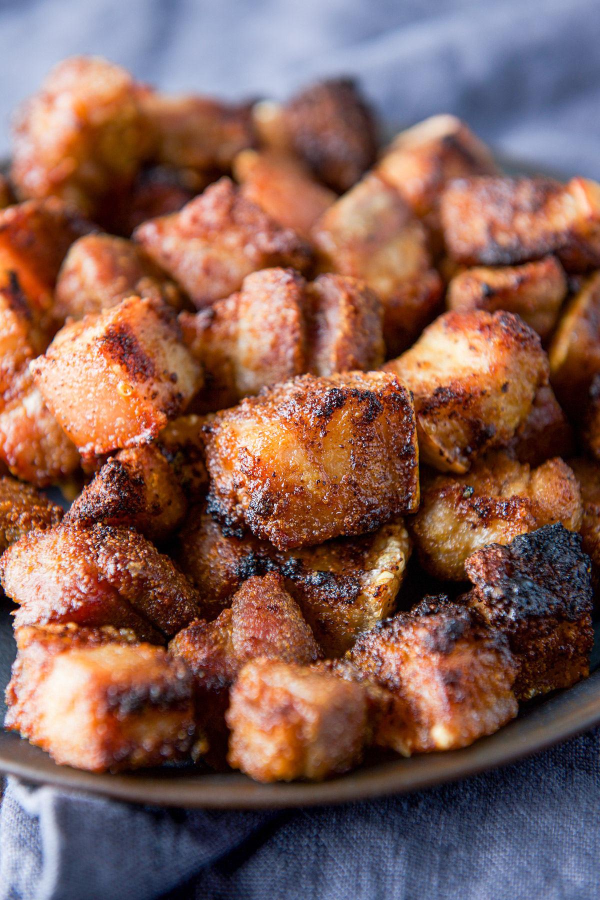 Close up of crispy pork bites on a metal tray