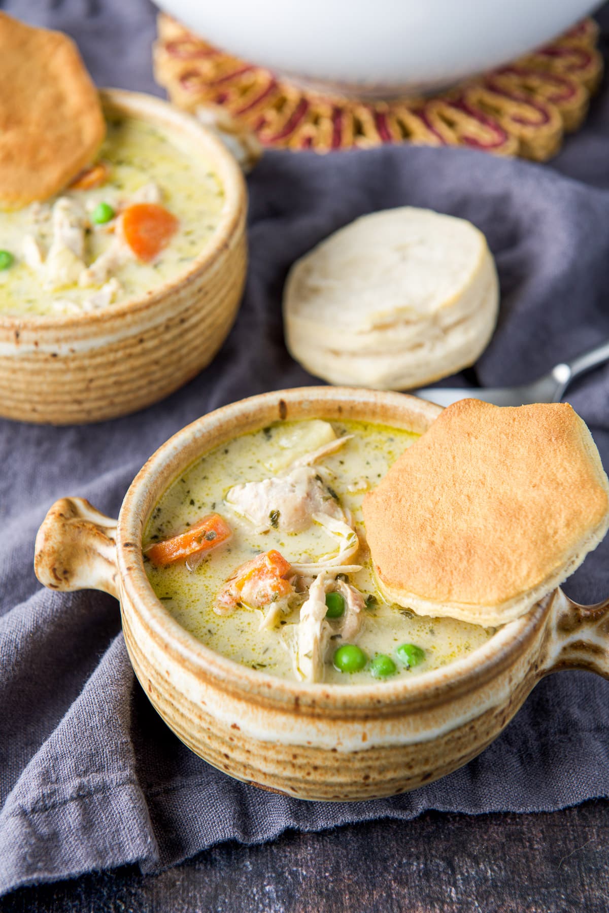 Biscuit tops on the two crocks of creamy chicken soup