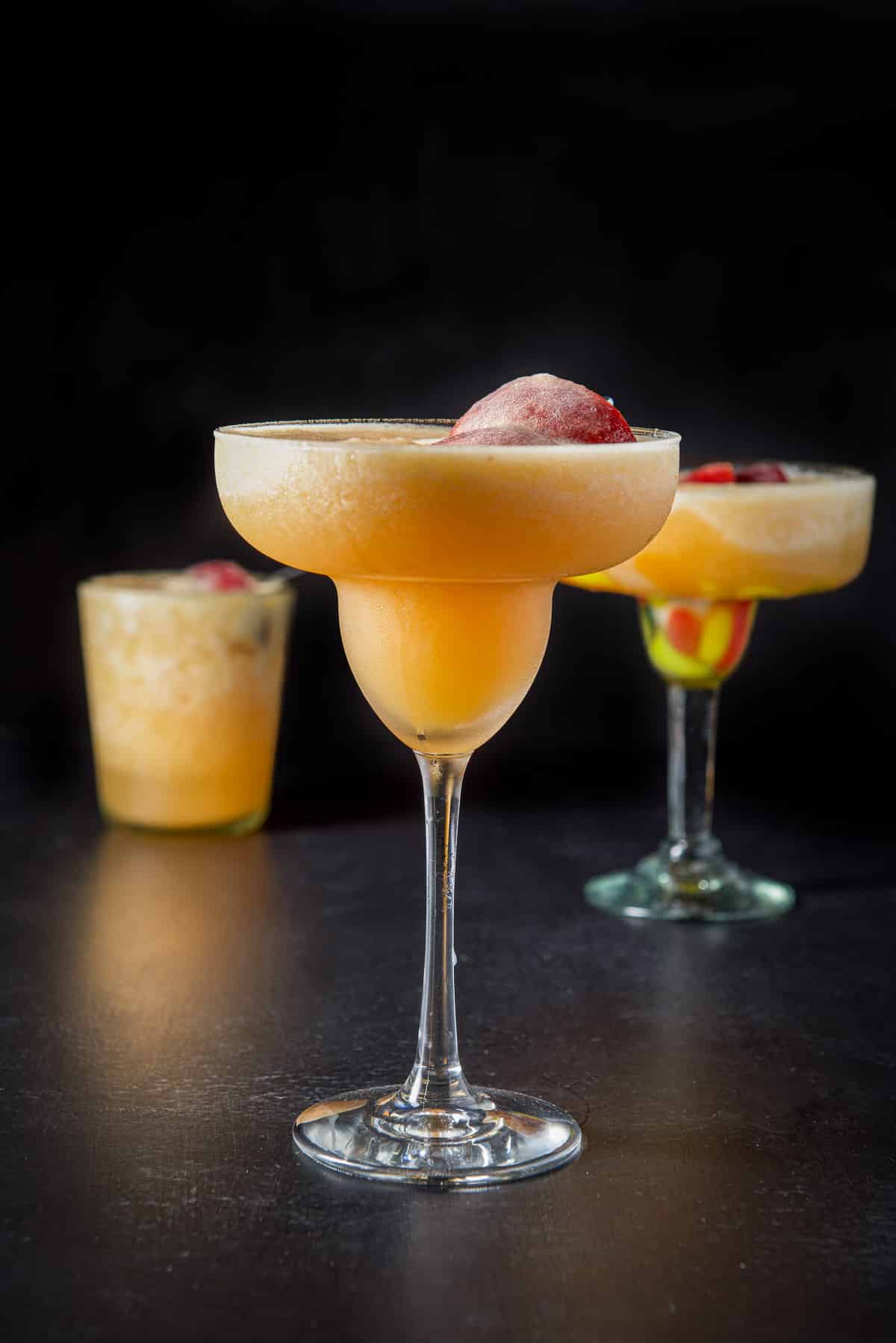 Vertical view of the three margarita glasses filled with the frozen drink