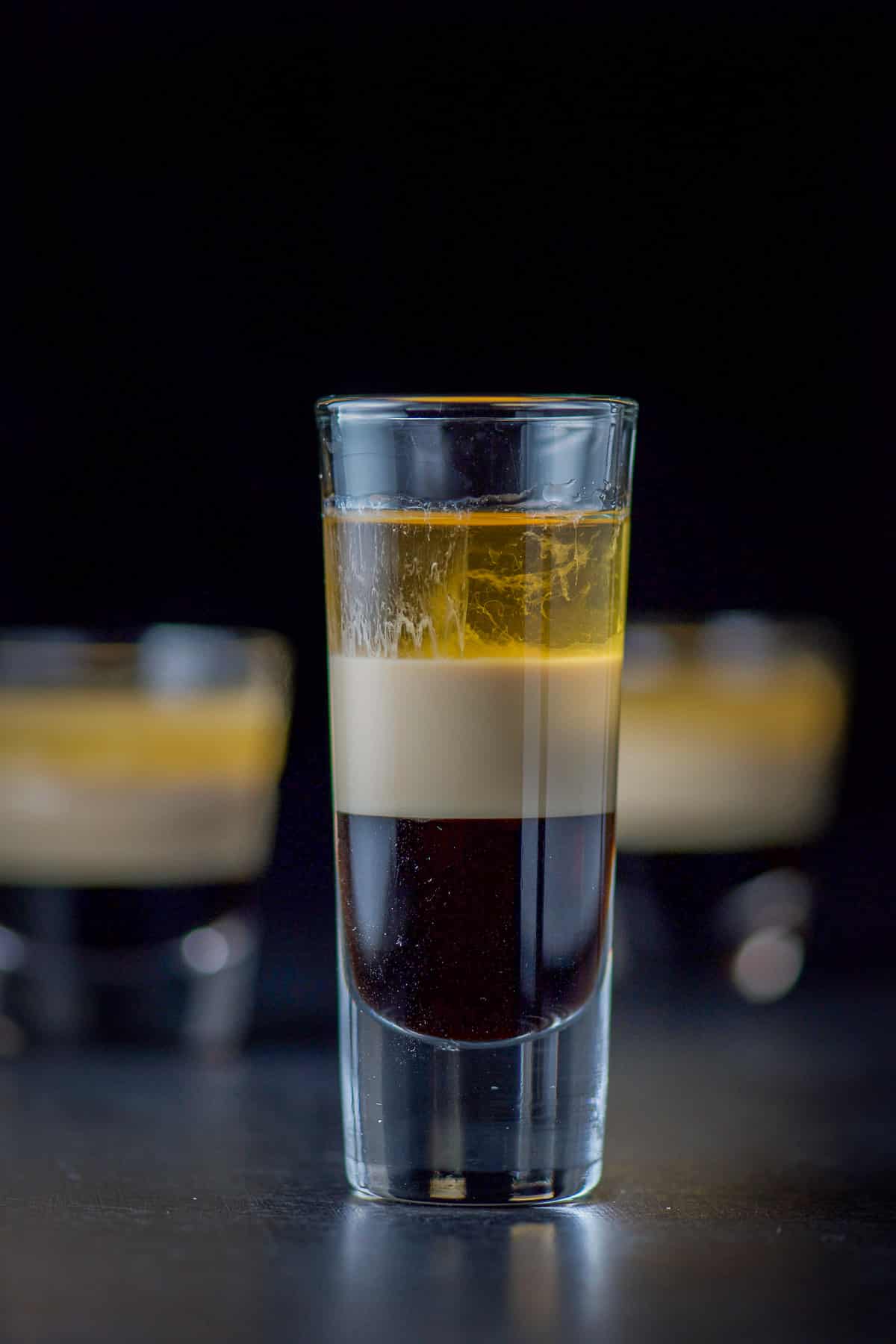 Close up of the tall glass filled with the layered B52