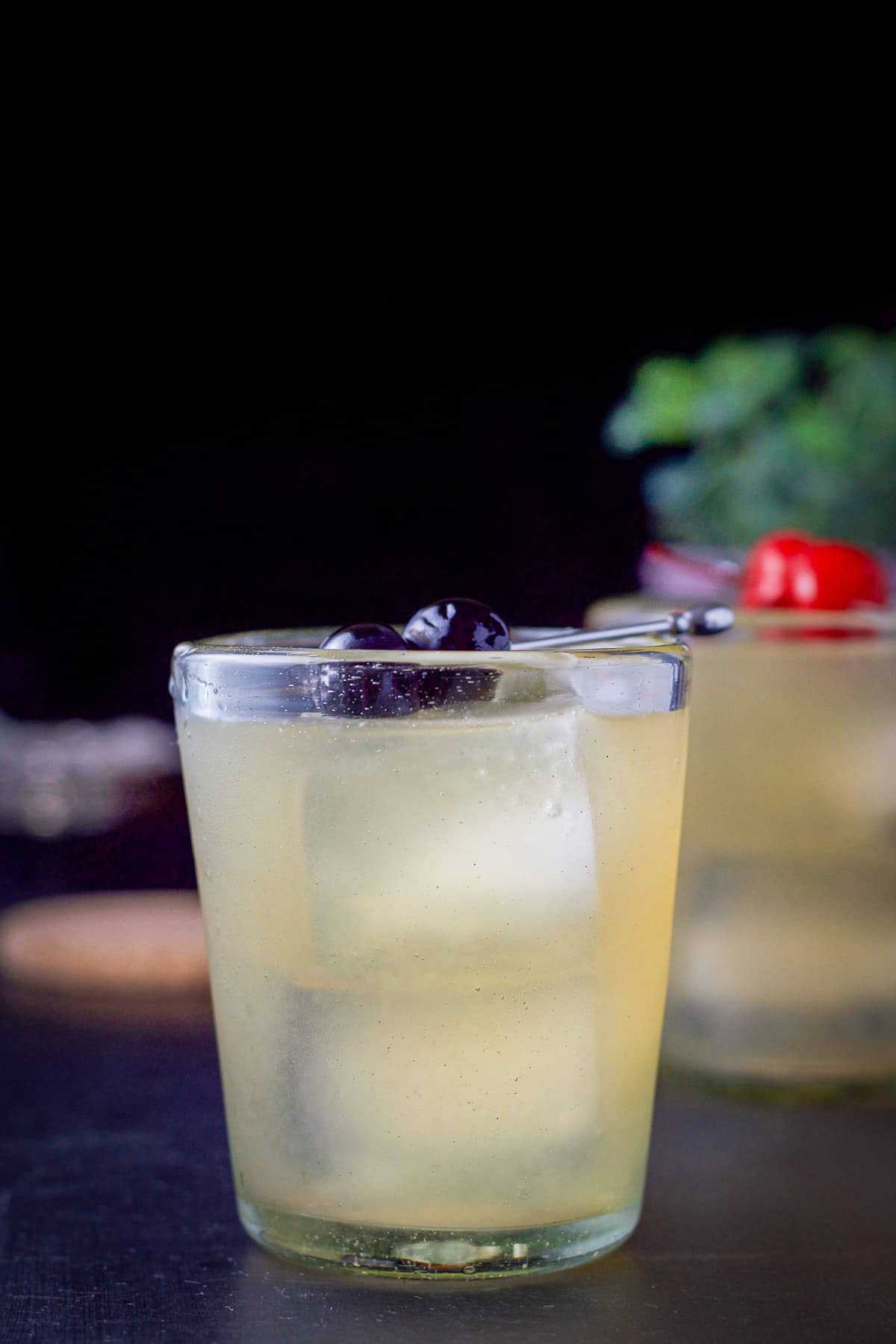 Vertical view of the whiskey sour with cherries as garnish