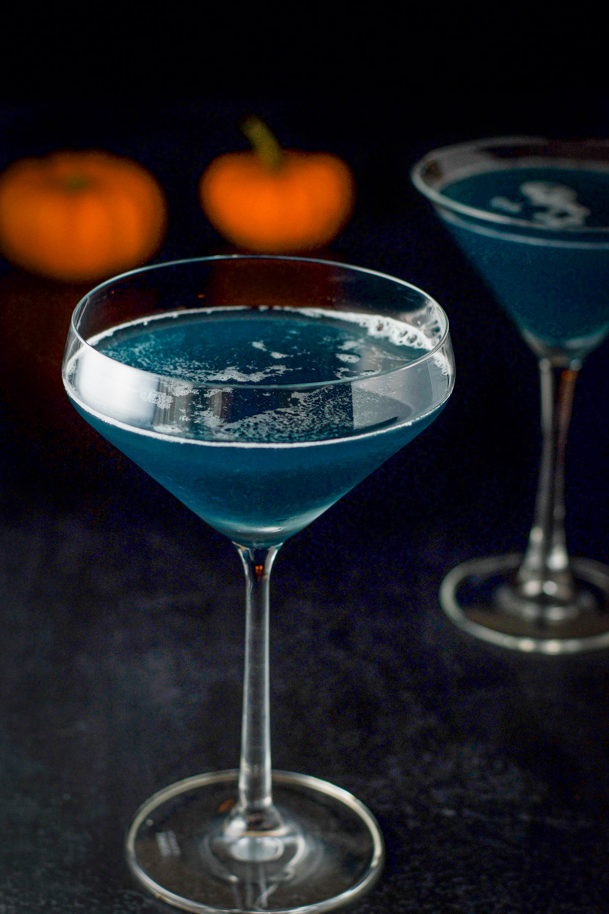 close up of a fluted martini glass filled with the witches brew