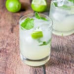 Square photo of the mojito with extra mint and a lime wedge