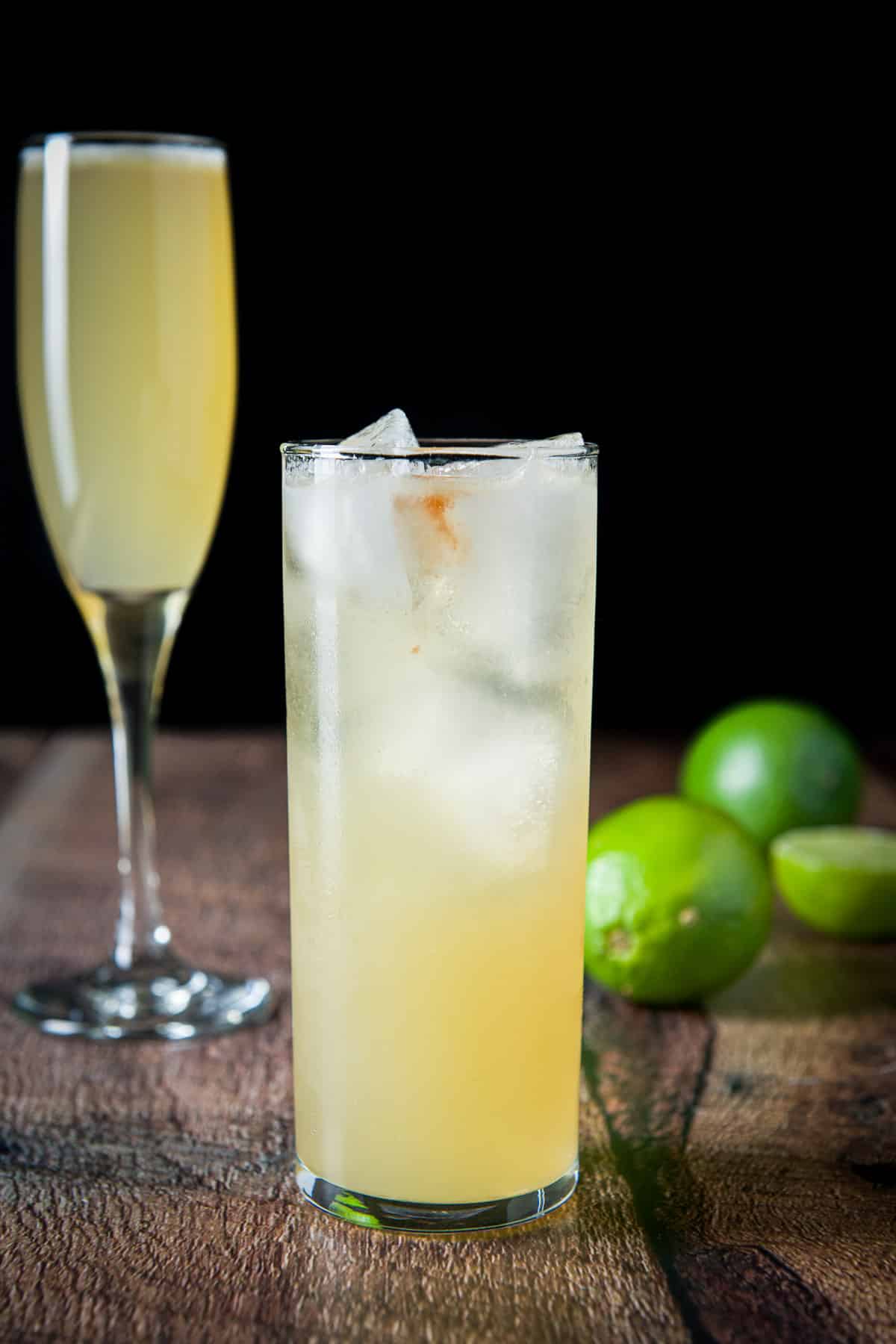 vertical view of the two glasses with the cocktail in them with the tall glass in front of the flute