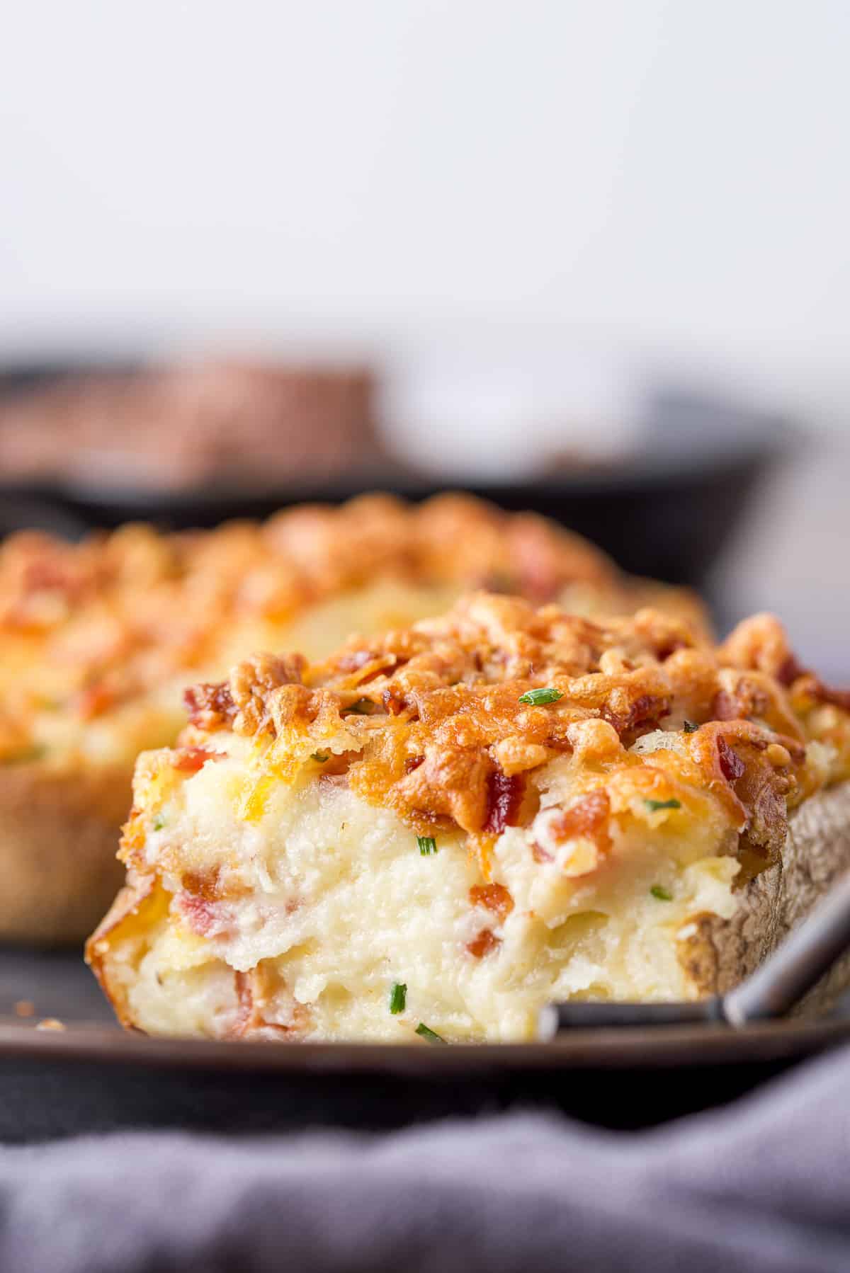 Creamy potato with cheese on top on a metal platter