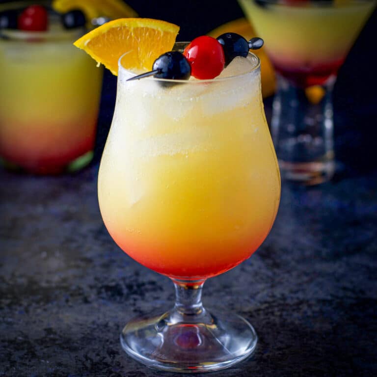 Three glasses filled with the tequila sunrise cocktail - square