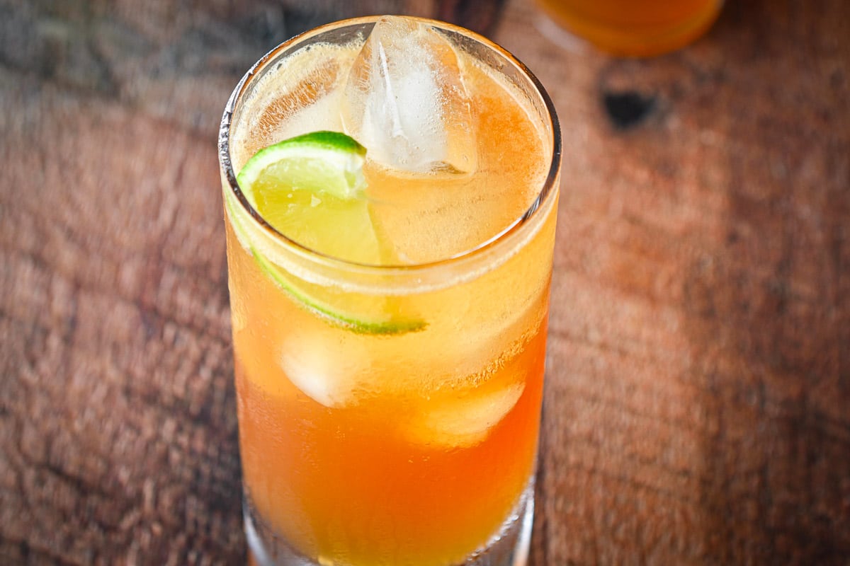 horizontal view of the dark and stormy cocktail with a piece of lime