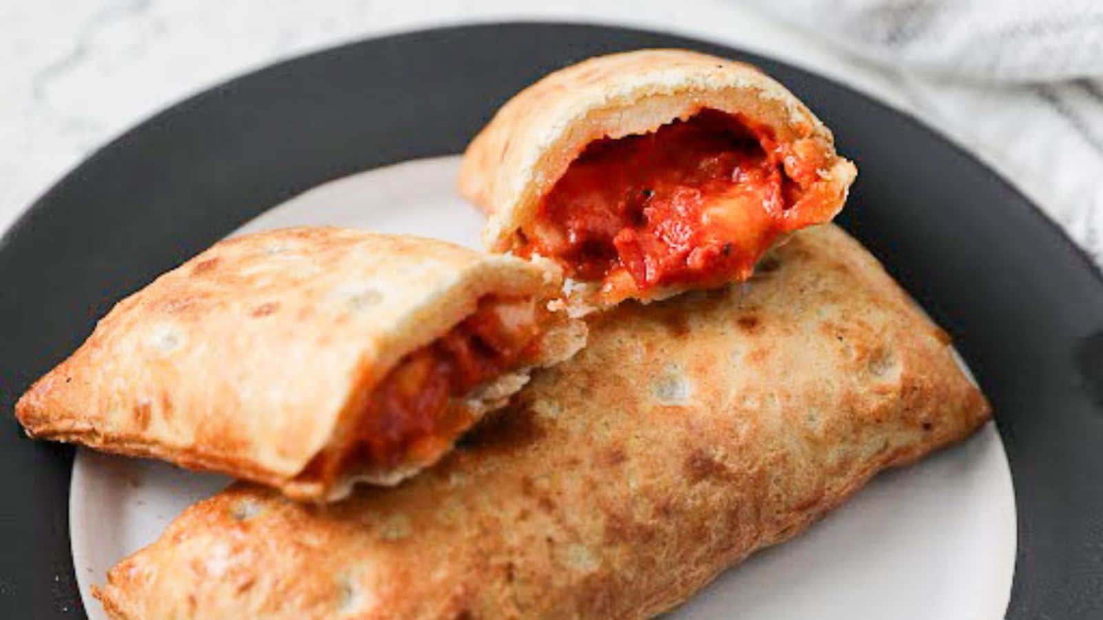 a hot pocket broken apart leaning on another hot pocket