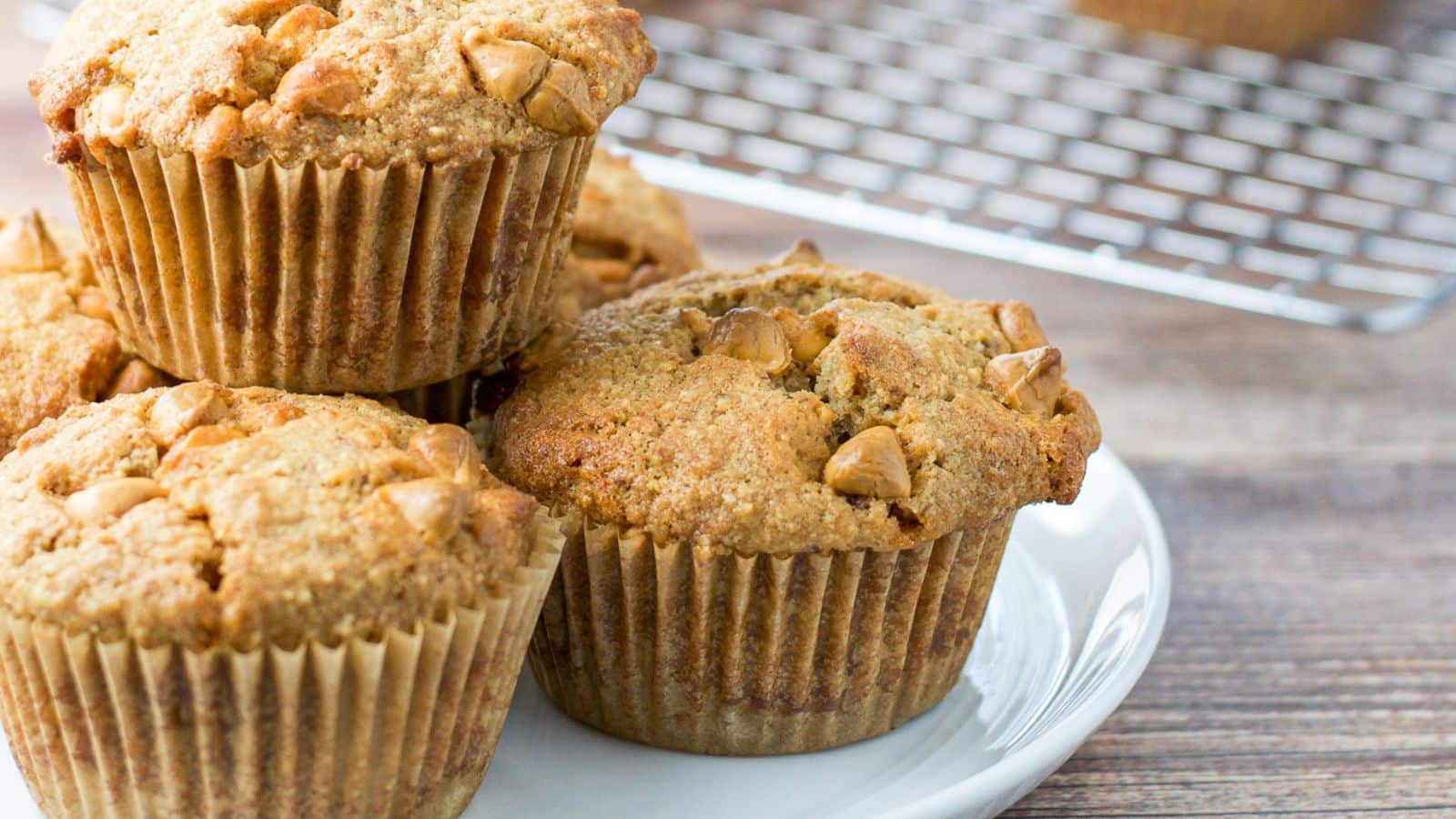 a small plate with muffins on it with butterscotch chips and a wire rack in the back