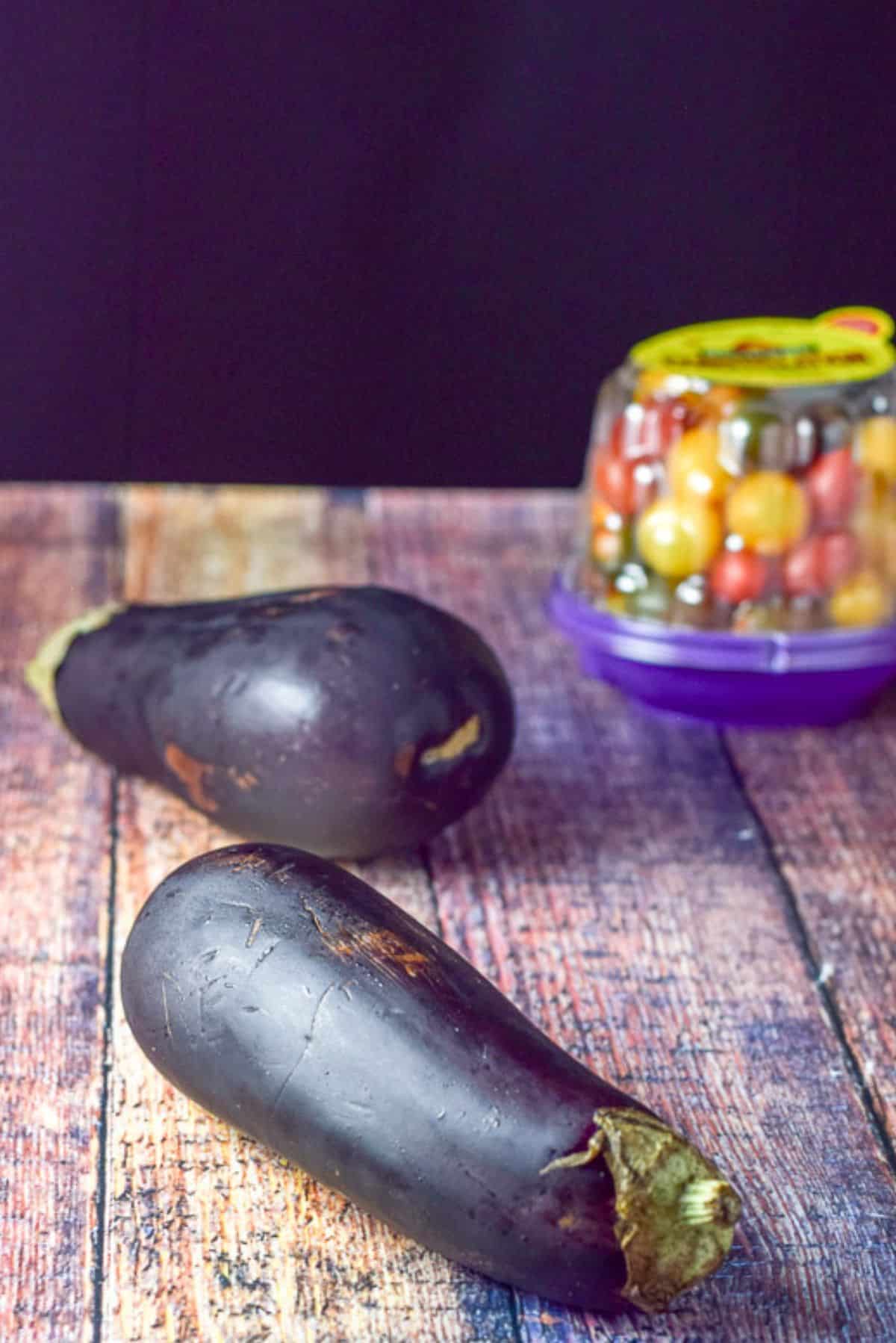 Eggplant and grape tomatoes on the wood table