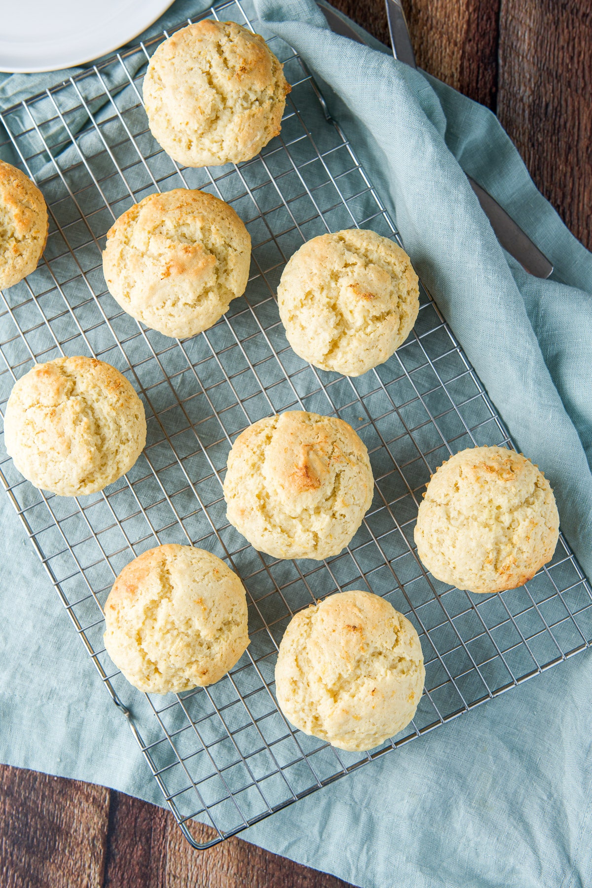Overhead view of muffins cooling on a wire rack - on a green napkin
