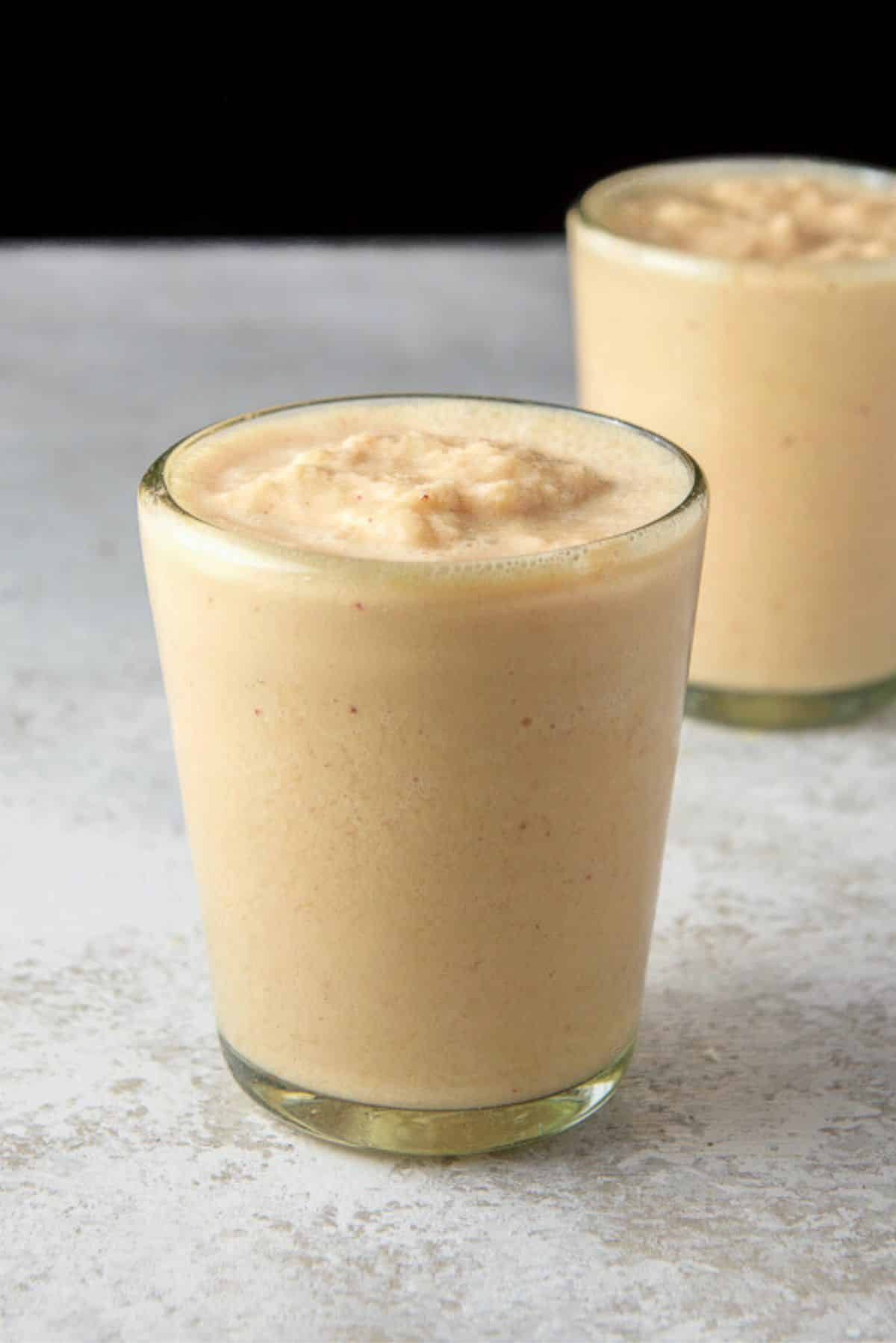 Close view of the mango smoothie in two glasses