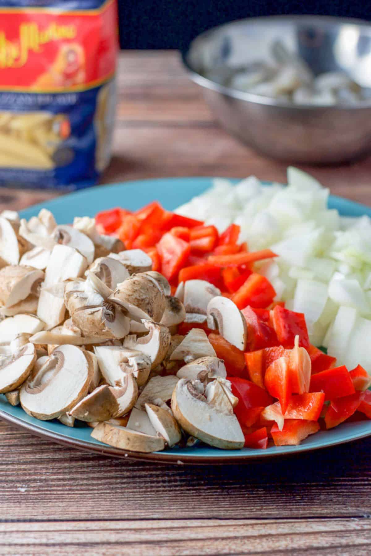 Cut up mushrooms, red bell peppers and onions for the easy shrimp scampi